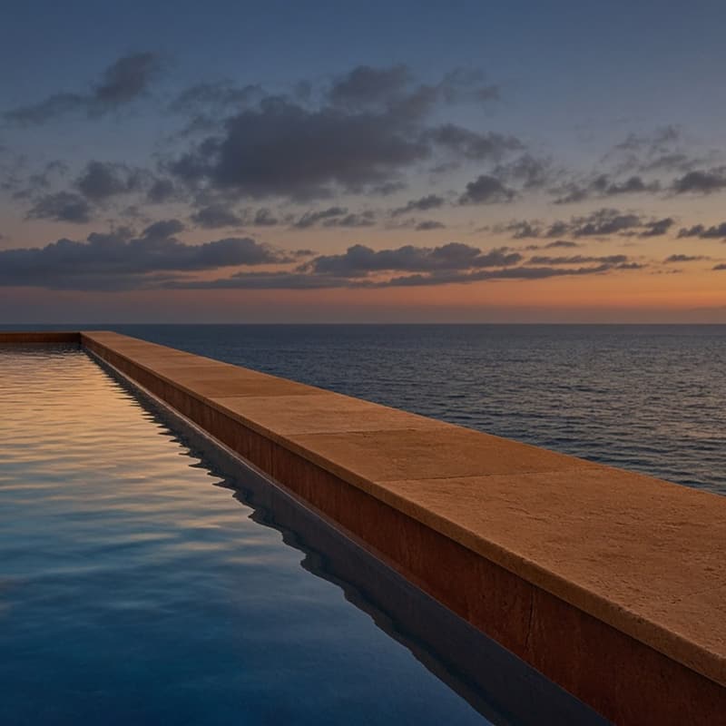 A long infinity pool edge meeting the horizon at twilight